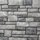 {Closeup detail of Harbor limestone veneer with black grout}