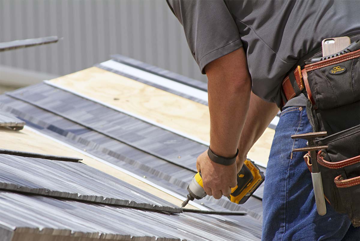 Closeup image of a contractor installing ProVia® Metal Roofing.