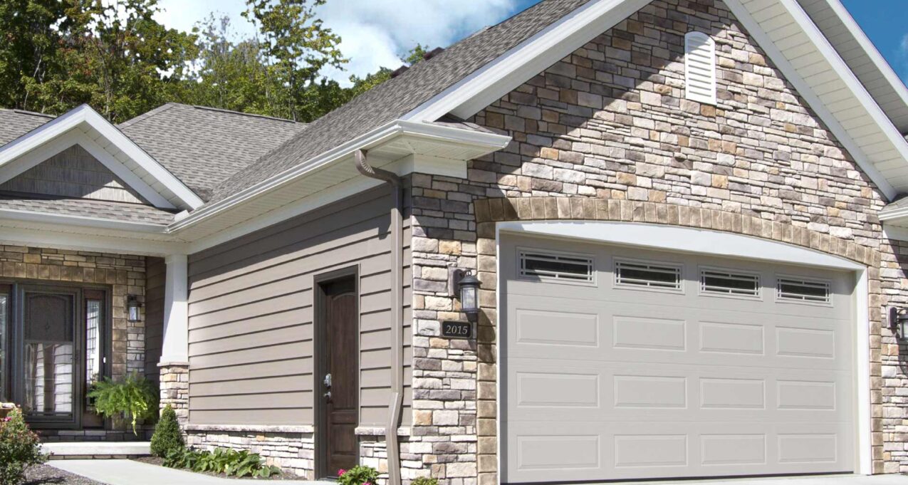 {Home with exterior stone veneer on a sunny day, demonstrating how sunlight affects stone color}