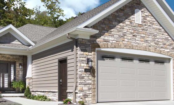 {Home with exterior stone veneer on a sunny day, demonstrating how sunlight affects stone color}