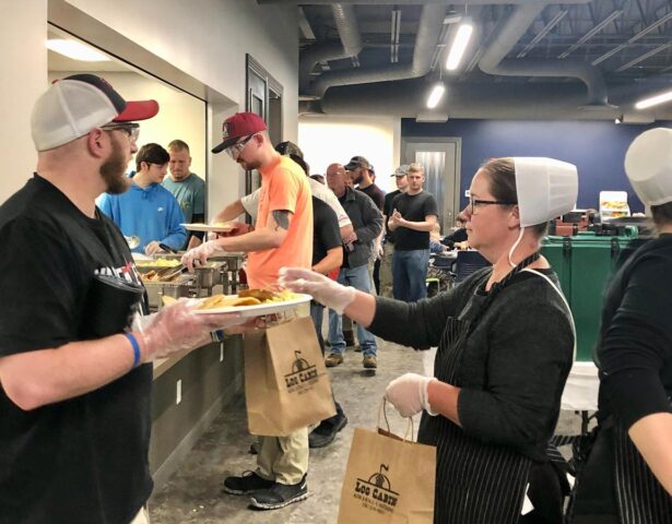 {ProVia employees line up for breakfast at a monthly corporate event.}