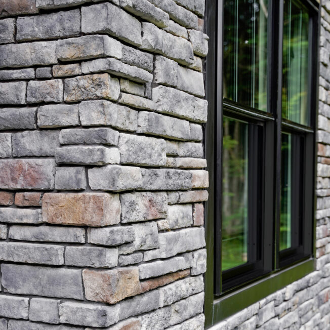 {Chisel Cut manufactured stone in the color Olympus on a home exterior}