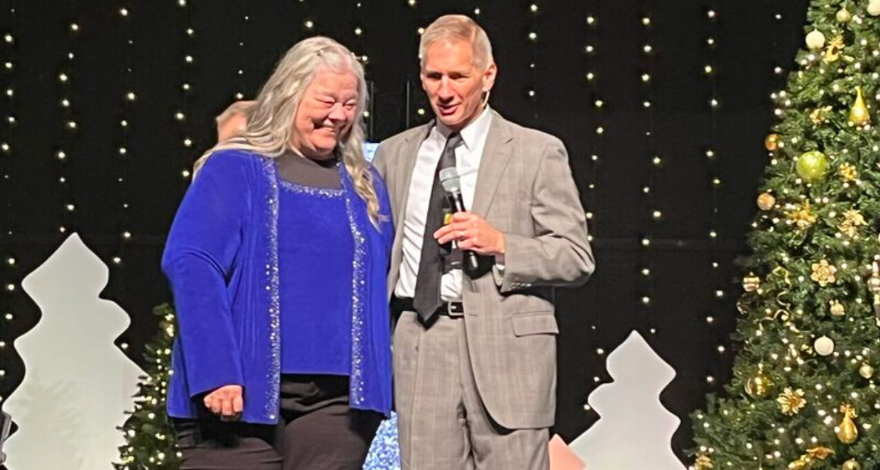 {ProVia employee Chris Ross celebrates her 50-year work anniversary at ProVia and is standing with ProVia President and CEO Brian Miller}