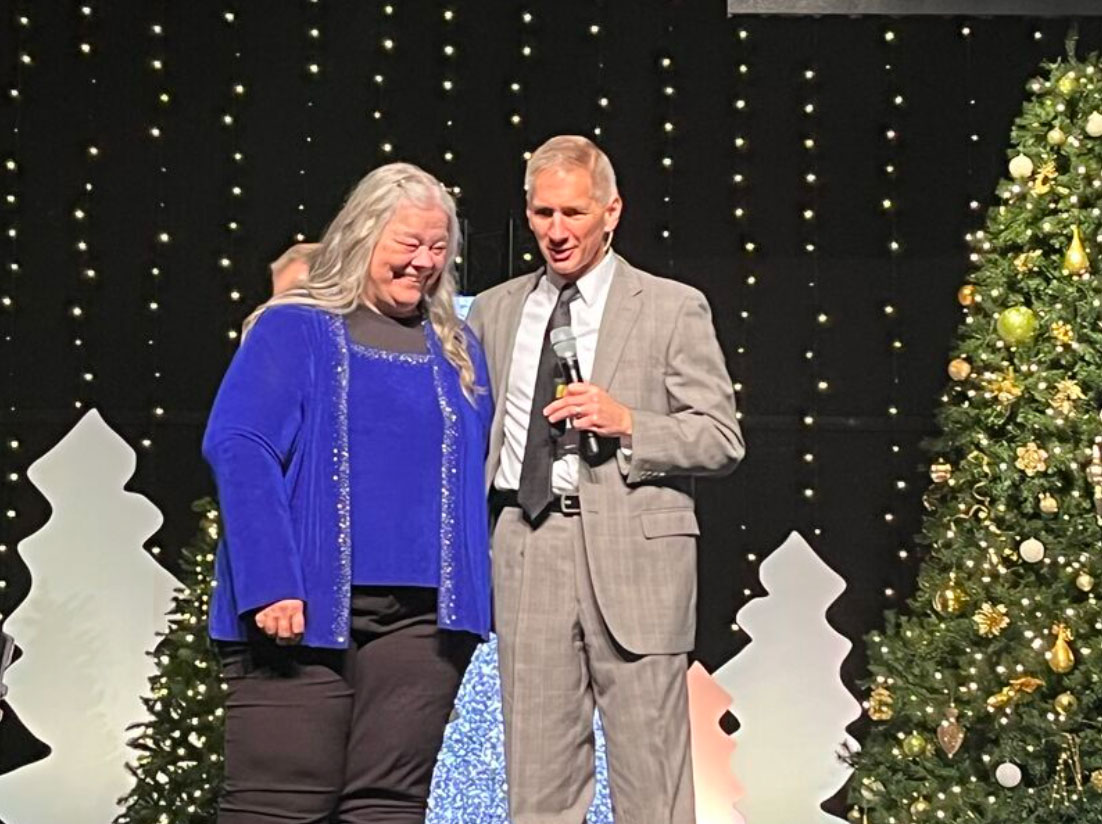 ProVia employee Chris Ross celebrates her 50-year work anniversary at ProVia and is standing with ProVia President and CEO Brian Miller