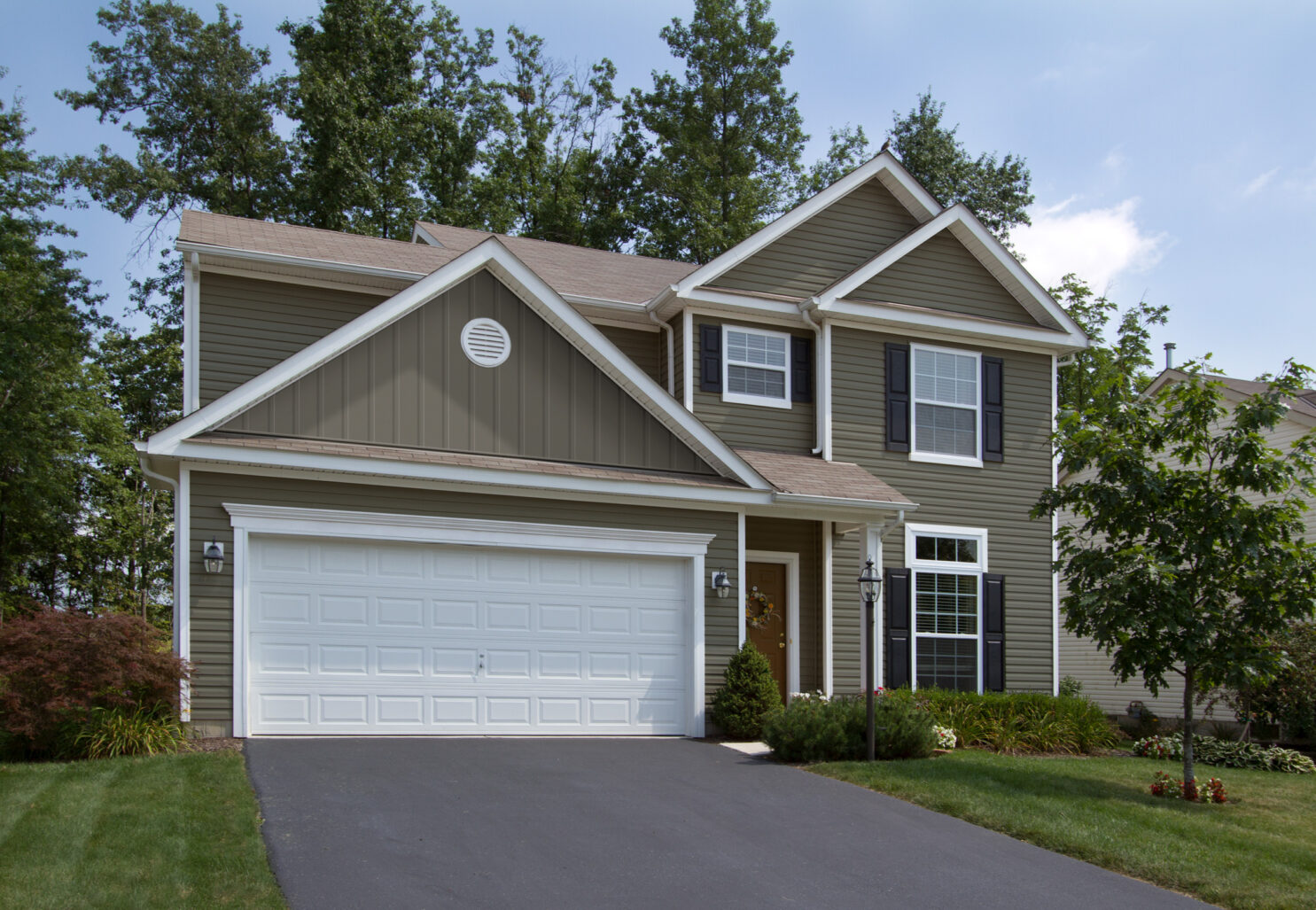 Two-Story House with Siding Accessories such as outside corner post, inside corner post, J-channel, F-channel, window and door surround, light block, board and batten, and round vent.