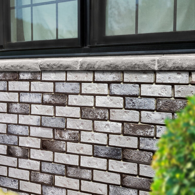 {Thin Brick manufactured stone in the color Cobblestone on the exterior of a home}