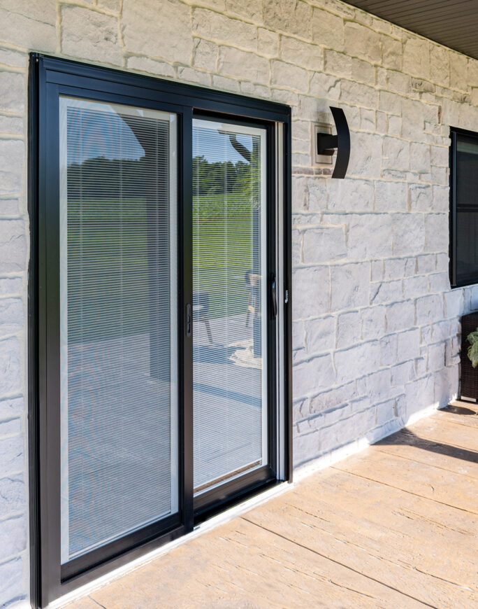 {Endure sliding glass patio door in Coal Black with white internal blinds}