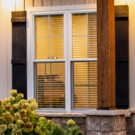 Closeup view of ProVia Endure™ white double hung replacement windows of a craftsman-style home