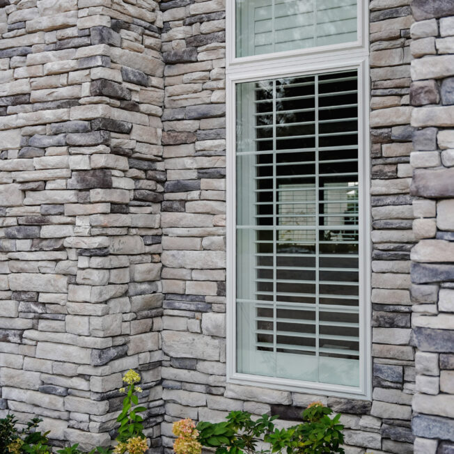 {Ledgestone Mystic Manufactured Stone veneer on the exterior of a home}