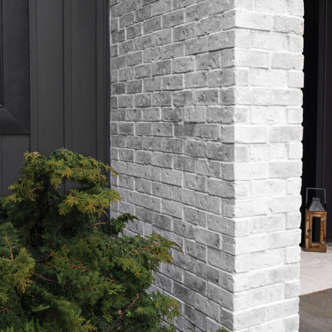 {Thin Brick Manufactured Stone in the color Delaware on a home exterior}