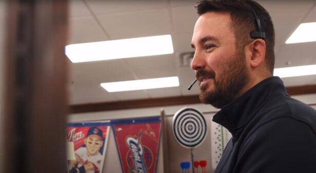{A ProVia customer service representative smiles as he talks on the phone with a customer}