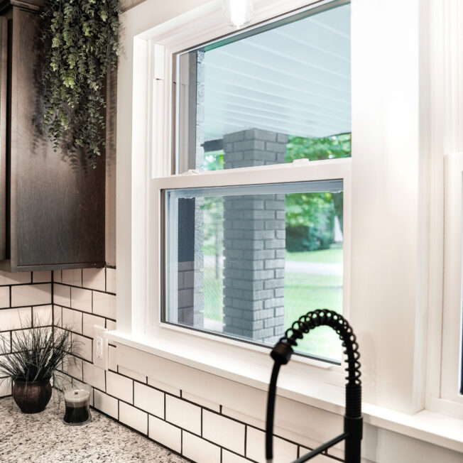 {EcoLite™ white single hung affordable windows in a kitchen with white subwaytiles}