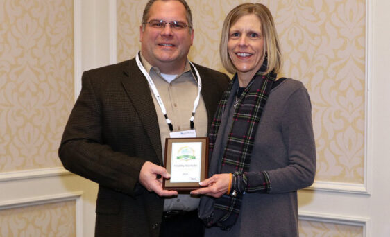 {Tricia Hicks (right), Wellness Specialist, accepts 2019 Gold award on behalf of ProVia}