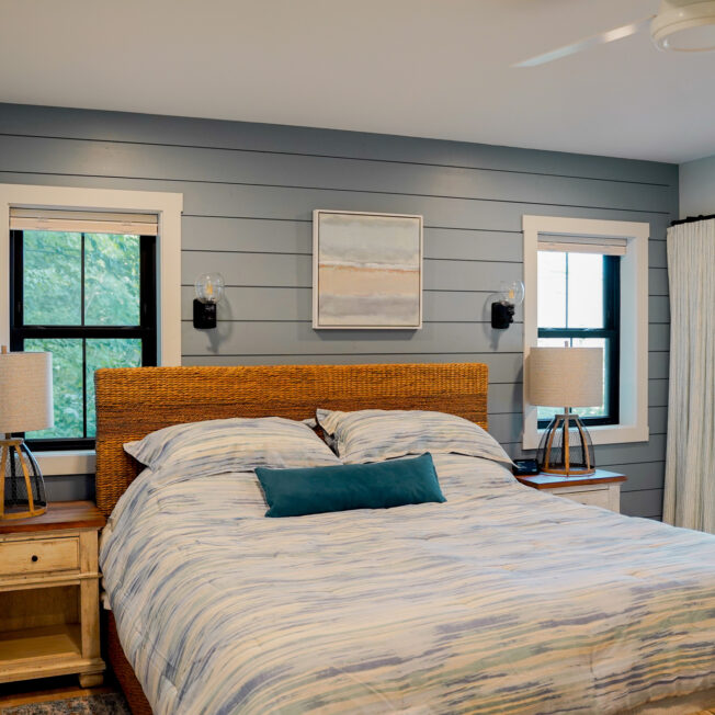 {Inside view of two Endure™ Double Hung Windows in Textured Matte Coal Black with Internal Grids in a bedroom}