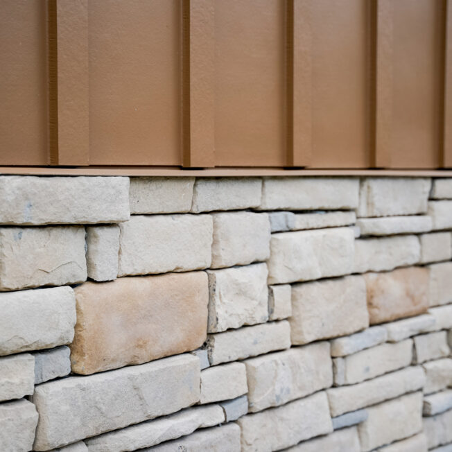 {Closeup view of Ottawa Dry Stack manufactured stone veneer on the outside of a home}