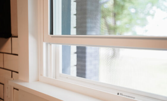 Closeup view of an open ProVia vinyl window showing the window screen
