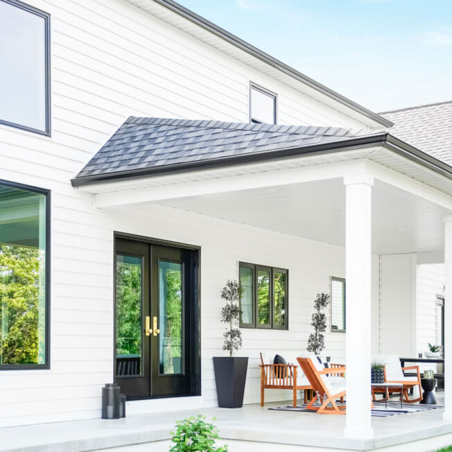{ProVia CedarMAX® Single 7″ Straight Lap insulated Vinyl Siding in White on a farmhouse-style home}