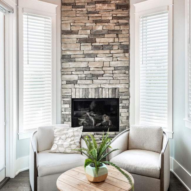 {Interior image of a ProVia Terra Cut™ Frost Manufactured Stone floor-to-ceiling Fireplace}