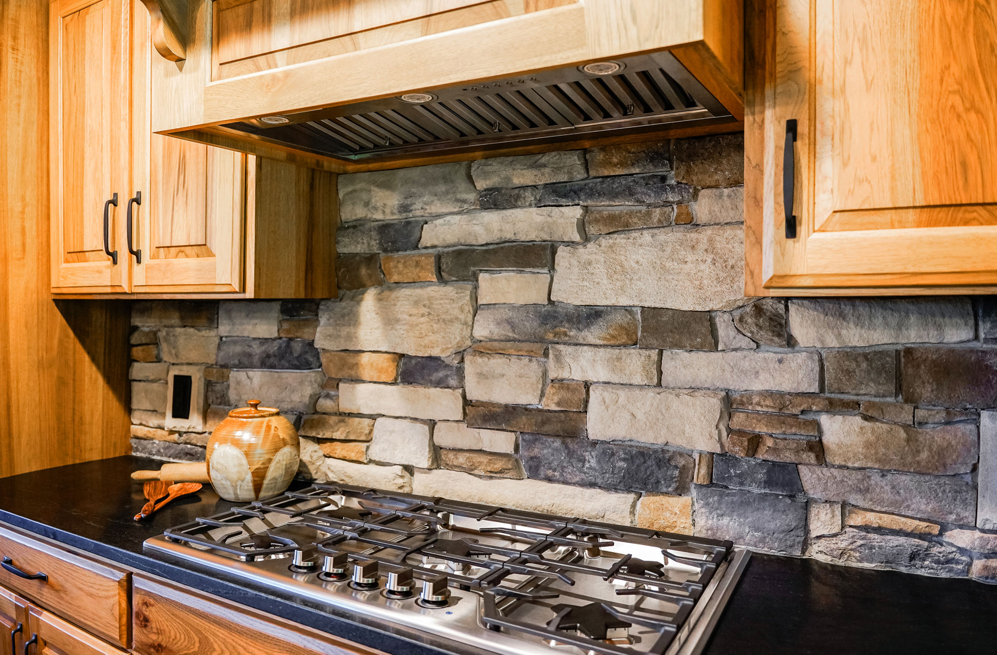 Warm interior image of ProVia Ledgestone Brighton with Fieldstone Strathmore Manufactured Stone in kitchen