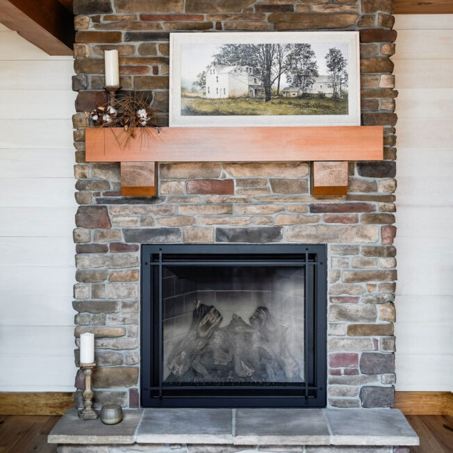 {Interior image of a floor-to-ceiling fireplace featuring ProVia Ledgestone in Saginaw with Fieldstone in Pennsylvania Manufactured Stone Fireplace}