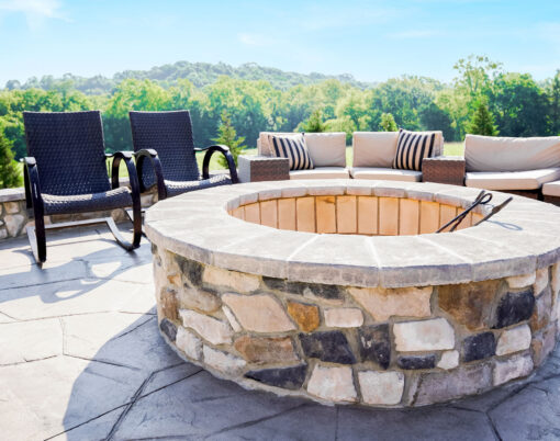 Scenic outdoor image of a ProVia Ridge Cut Denali™ manufactured stone firepit