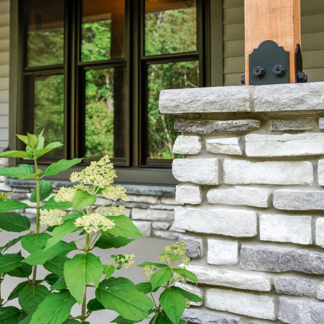 {Closeup of ProVia Terra Cut™ Frost Manufactured Stone on a home exterior and porch column}