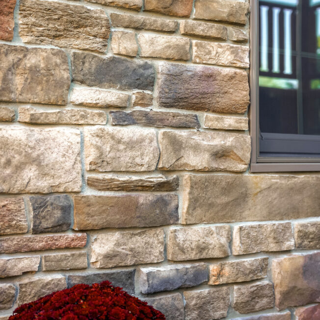 {Closeup of ProVia Terra Cut™ Russet Manufactured Stone on home exterior}