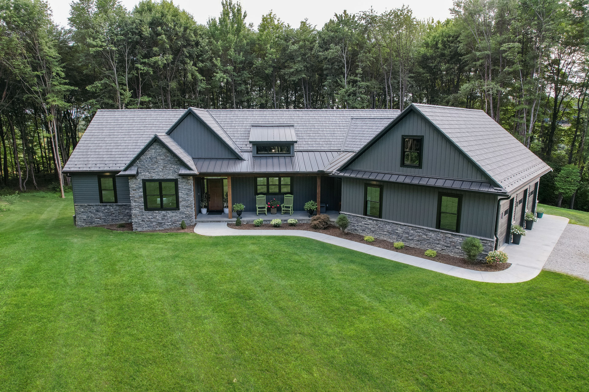 Ranch home showcasing home exterior solutions with ProVia doors, windows, siding, stone, and roofing.