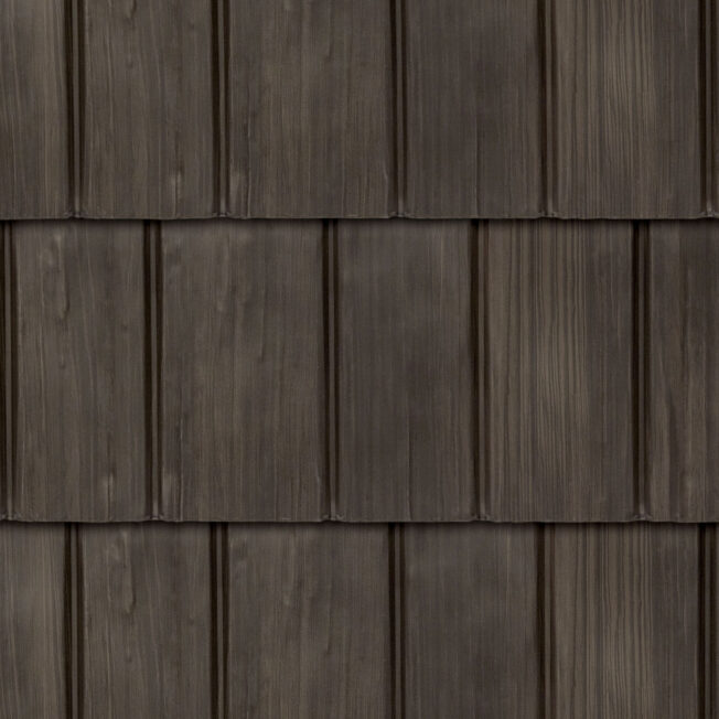 {Closeup image showing the details of ProVia's Bronzewood dark brown colored shake metal shingle roof, example of metal roofing that looks like shake}