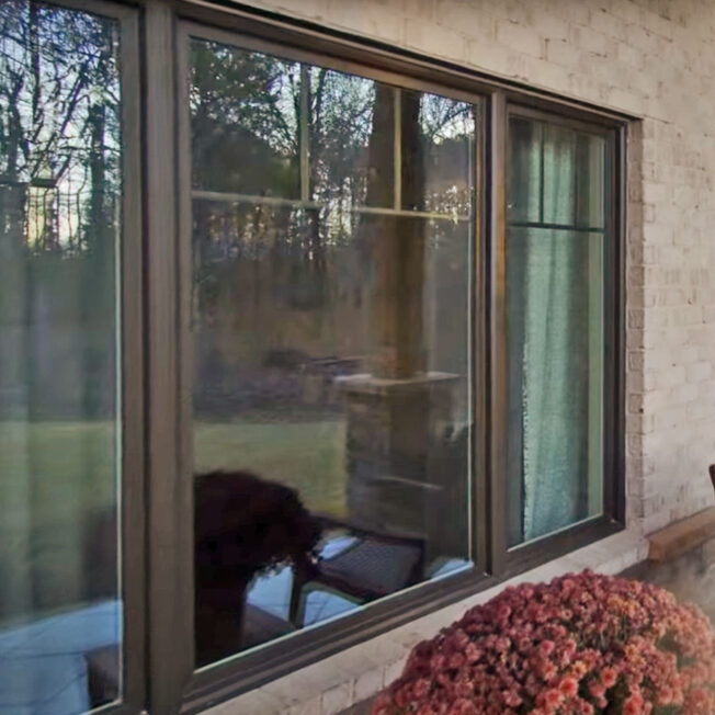 {Closeup exterior image of ProVia Aeris™ Windows in Classic Bronze with Internal Grids}