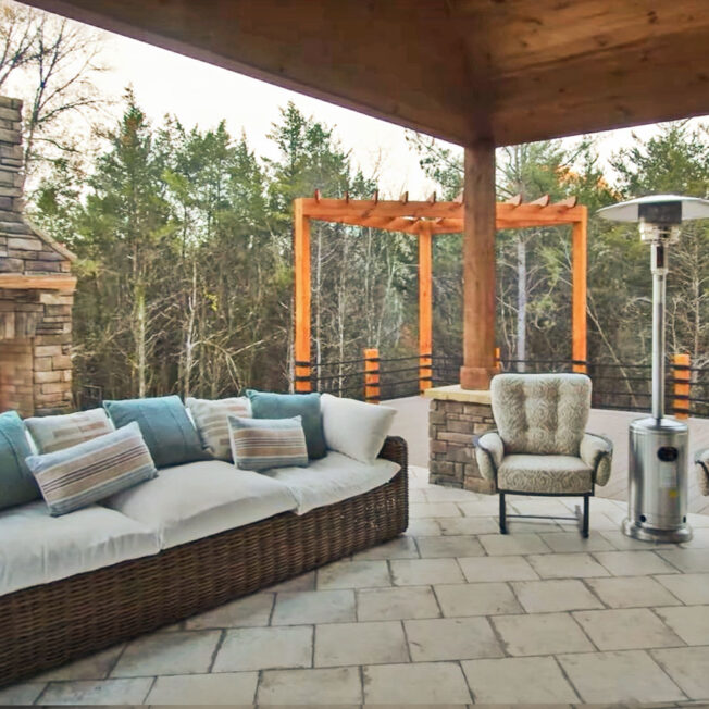 {Image of an outdoor patio area with an outdoor fireplace with manufactured stone veneer in Shawnee Dry Stack}