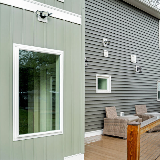 {Cedar Peaks® Board and Batten in Aspen on the back of a home with a deck}
