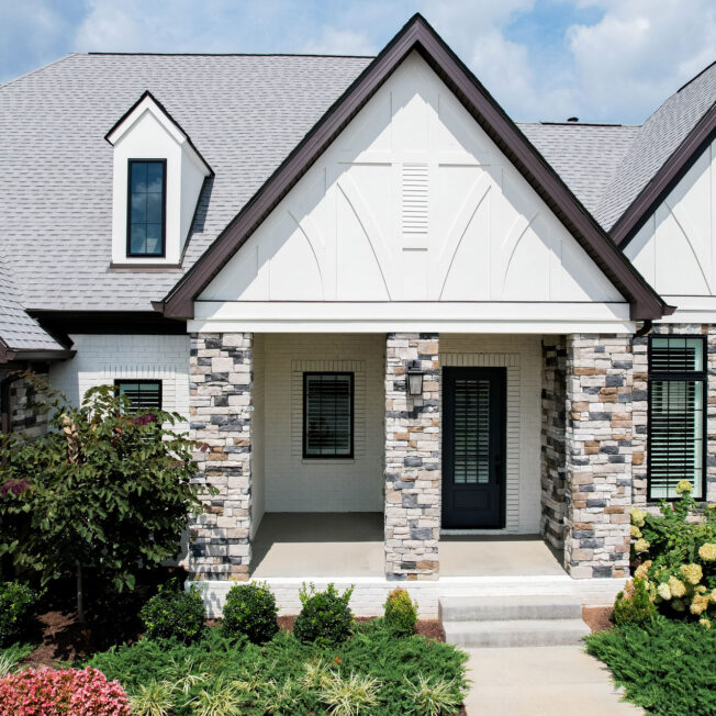 {Home exterior image showing ProVia Terra Cut™ Niagra & PrecisionFit™-Arctic manufactured stone veneer}