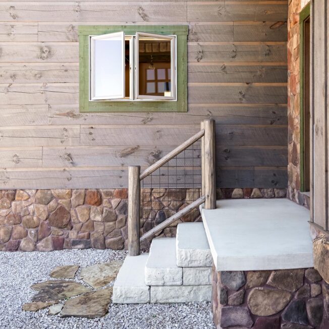 {Brown and tan field stone veneer manufactured stone, Shenandoah, featured on the foundation of a house}