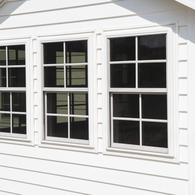 {Home exterior with ProVia CedarMAX® Double 6″ Straight Lap Vinyl Siding in White}