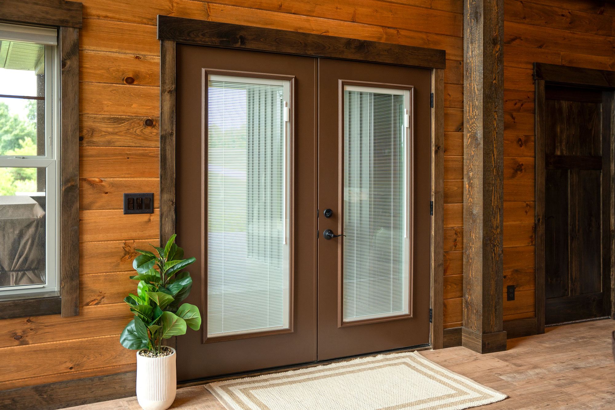 Home exterior with ProVia Legacy™ 460 Steel French Doors in Tudor Brown with Internal Blinds