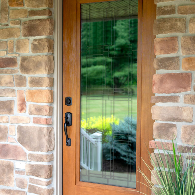 {Exterior view of a ProVia Signet® Fir 420 entry door in Caramel stain with Laurence Art Glass}