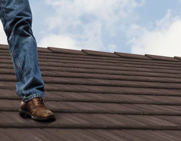 Closeup of a contractor standing on a ProVia metal roof