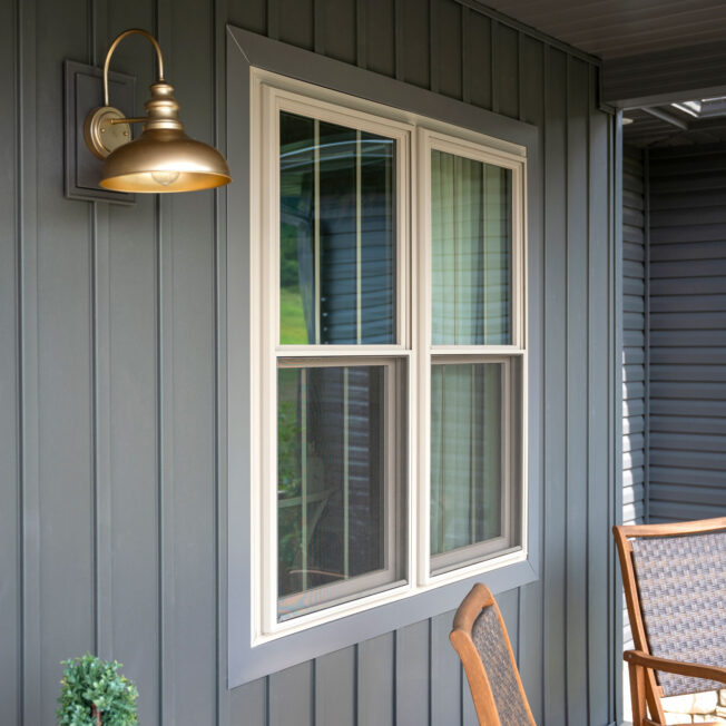 {Exterior view of ProVia® Endure™ Double Hung Windows in Sandstone with Cottage Grids}