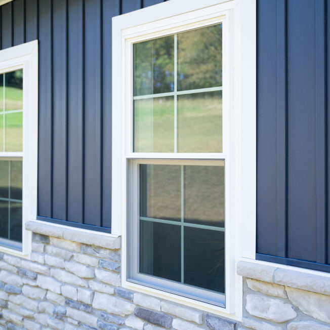 {Exterior view of ProVia® Endure™ Double Hung Windows in White with contoured internal cottage grids}