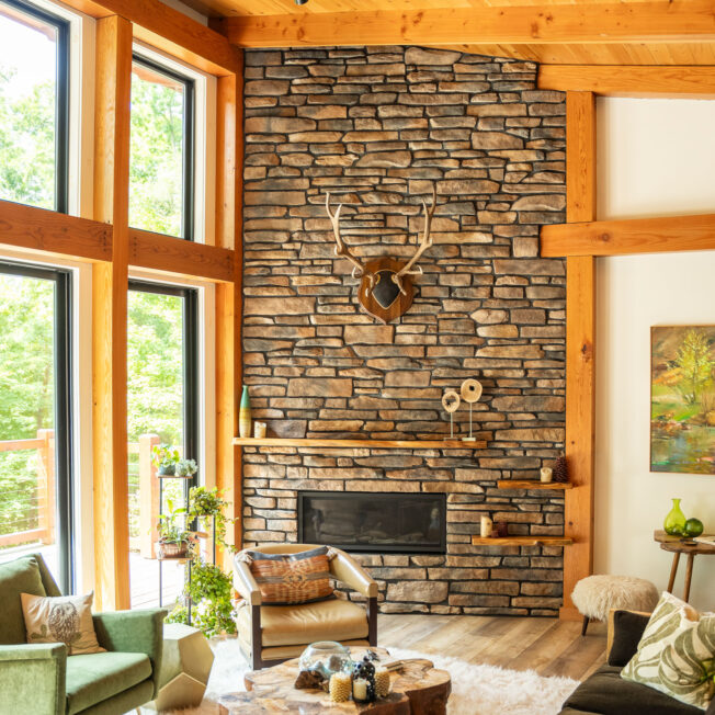 {Inside view of ProVia Ledgestone Rushmore Manufactured Stone on a floor-to-ceiling fireplace surround}