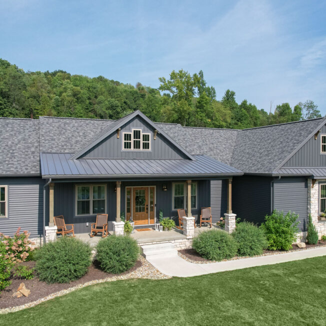 {Home exterior showcasing ProVia® CedarMAX® Board and Batten siding and HeartTech® double 5" vinyl siding in Nautica}
