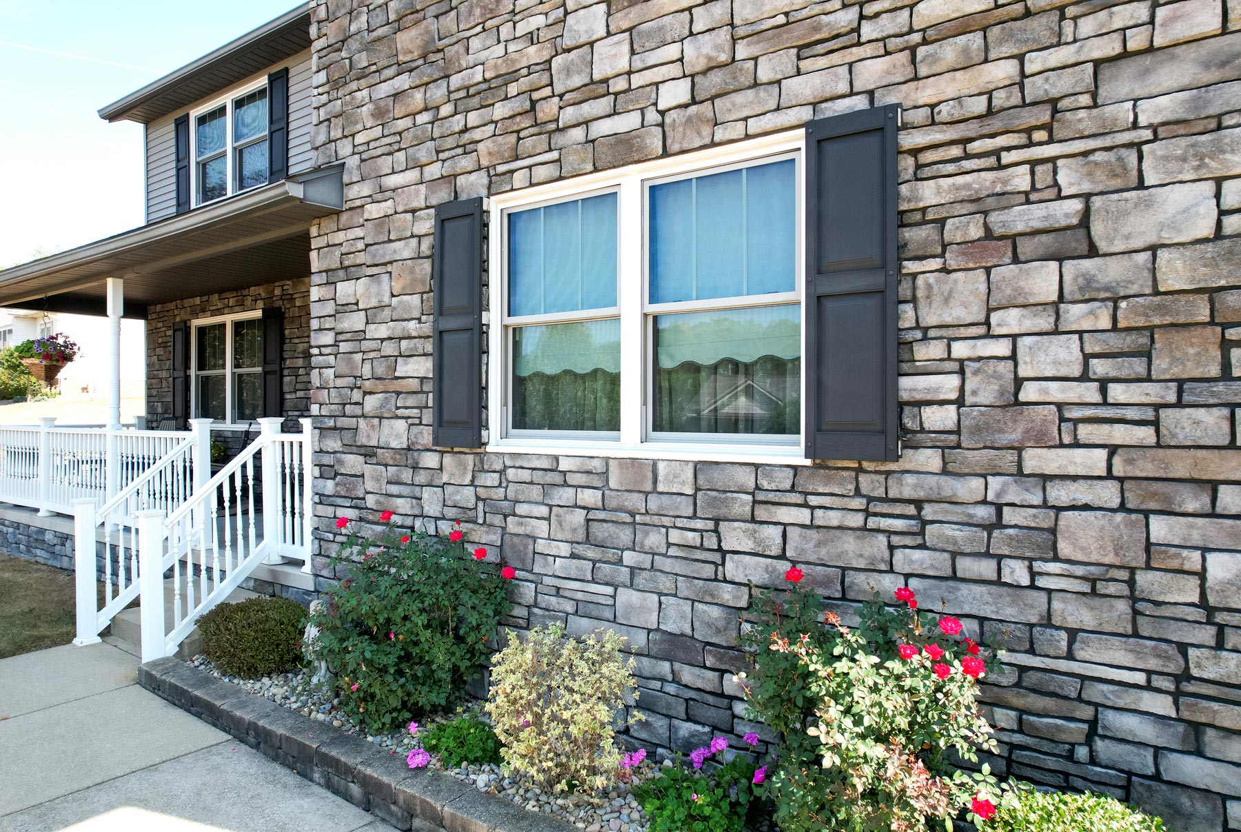Home exterior featuring ProVia® Terra Cut manufactured stone veneer in the color Slate