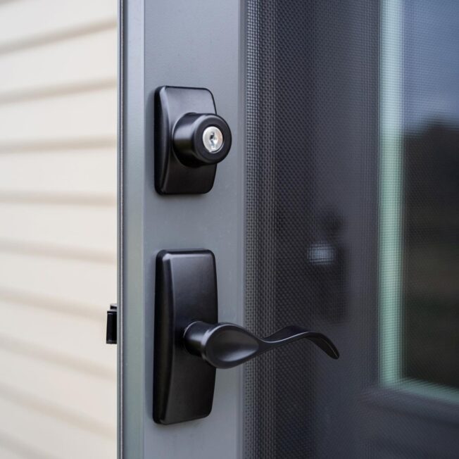 Contemporary Curve Storm Door Hardware in Black on a dark gray Nightfall ProVia® storm door