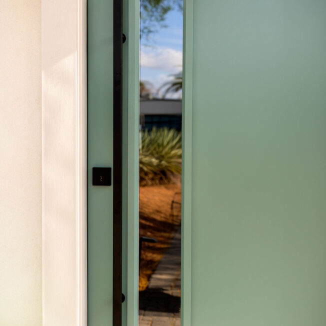 Emtek® Square Entry Door Pull Bar in Black on a Eucalyptus green ProVia® entry door