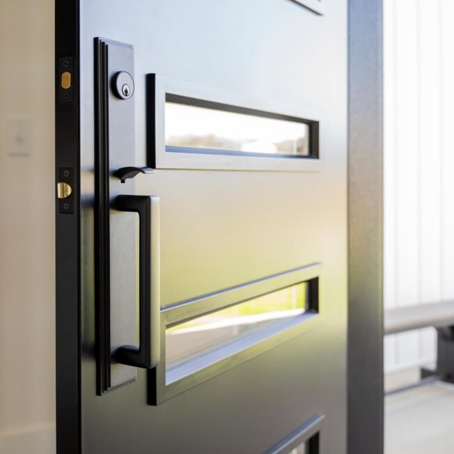 Closeup of Emtek® Melrose Entry Door Hardware in Black on a ProVia® entry door