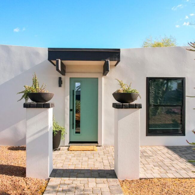 Exterior view of a ProVia® Legacy™ Smooth Steel 111 Entry Door in Eucalyptus with a Black Emtek® Square Pull Bar on a modern home exterior style
