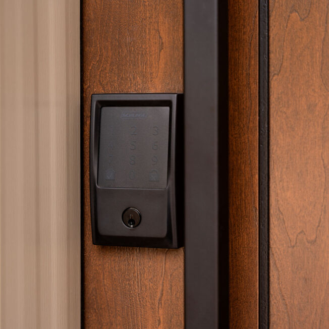 Closeup of a Schlage® Encode Plus™ Smart WiFi Deadbolt in Black with Century Trim on a ProVia® entry door