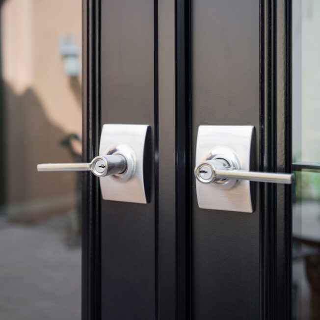 Closeup of Schlage® Classic Latitude Lever entry door hardware in Satin Nickel with Century Trim on a set of ProVia® French doors
