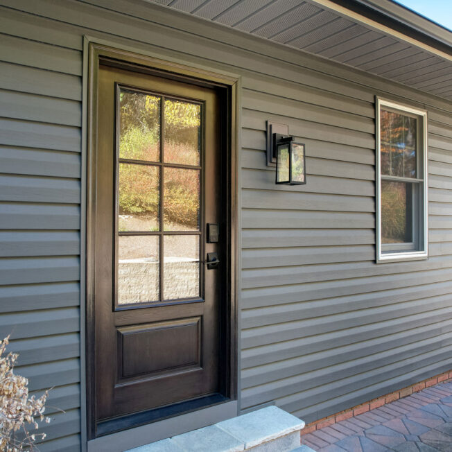 Exterior view of ProVia® CedarMax® Double 6" Dutch Lap Vinyl Siding in Nightfall